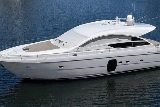 Slide: The Image of 2013 Pershing 64 yacht on calm water, showcasing sleek design and luxury features. - 2