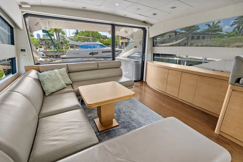 Slide: The Image of Luxurious interior of a 2013 Pershing 64 yacht with leather seating and wooden cabinetry. - 20