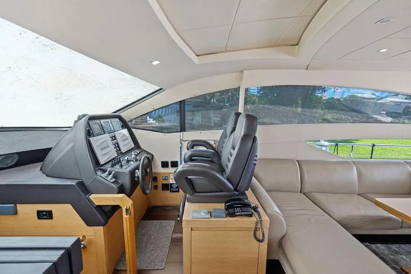 Slide: The Image of Luxurious interior of a 2013 Pershing 64 yacht with modern helm and seating. - 24