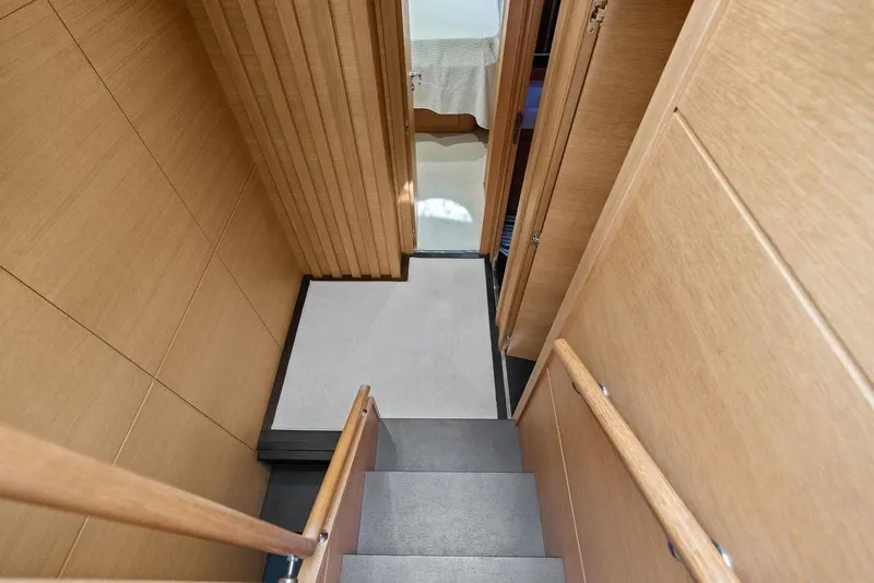 Slide: The Image of Interior staircase of 2013 Pershing 64 yacht with wooden paneling and modern design. - 27