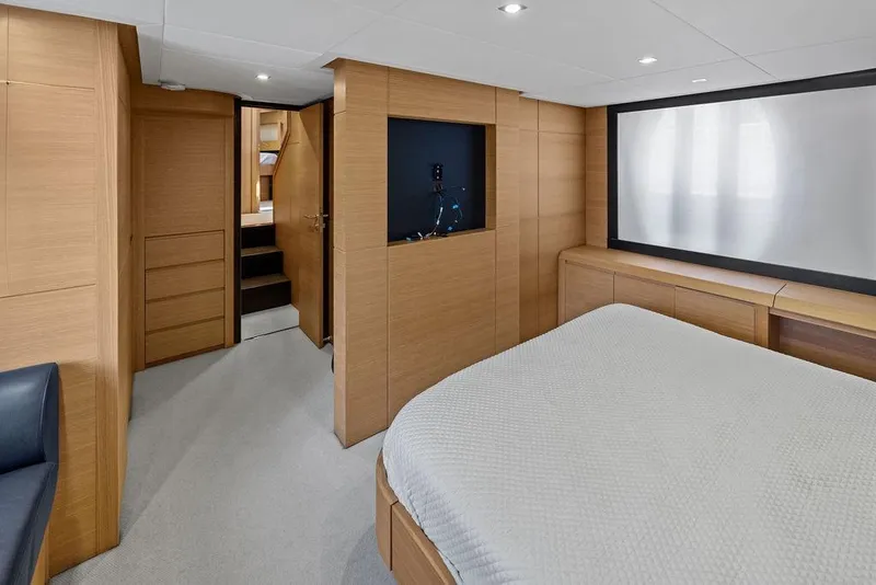 Slide: The Image of Luxurious interior of 2013 Pershing 64 yacht with modern wood paneling and cozy bedroom. - 31