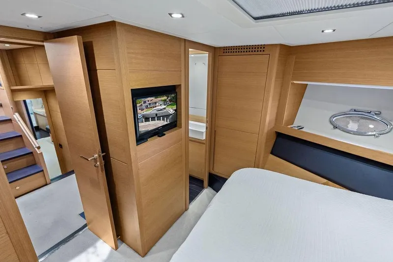 Slide: The Image of Luxurious interior of 2013 Pershing 64 yacht with modern wood finishes and cozy bedroom. - 36