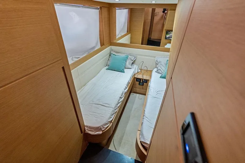 Slide: The Image of Luxurious twin cabin interior of 2013 Pershing 64 yacht with modern wood finish. - 39