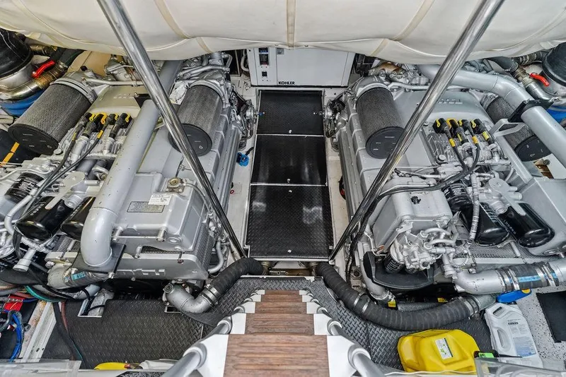Slide: The Image of Engine room of a 2013 Pershing 64 yacht, showcasing dual engines and mechanical components. - 46