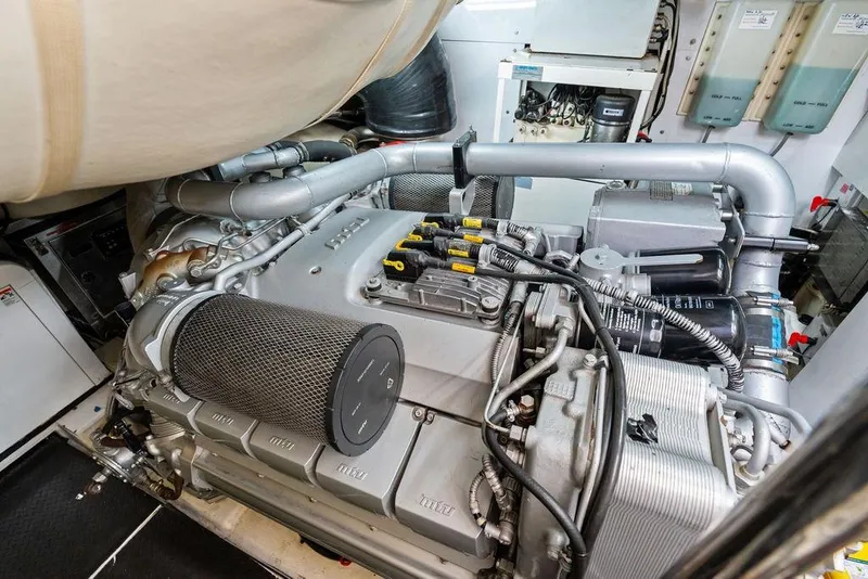 Slide: The Image of Engine room of a 2013 Pershing 64 yacht, showcasing detailed machinery and components. - 47