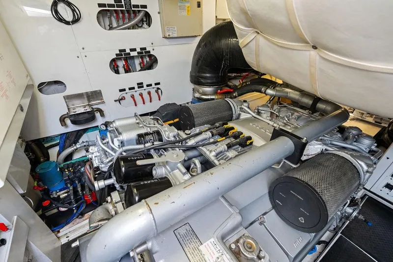 Slide: The Image of Engine room of a 2013 Pershing 64 yacht, showcasing mechanical components and systems. - 48