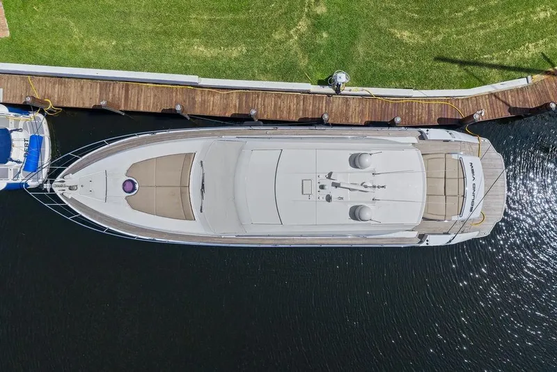 Slide: The Image of Aerial view of 2013 Pershing 64 yacht docked by a wooden pier. - 5