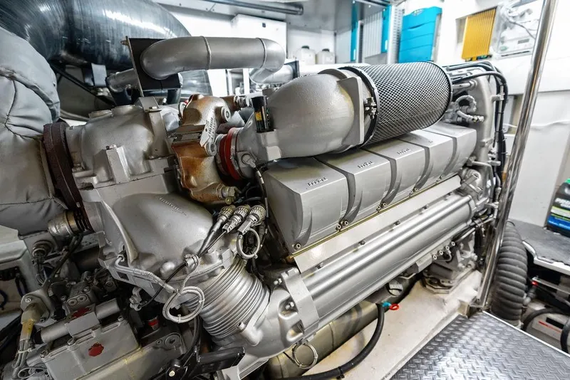 Slide: The Image of Engine room of a 2013 Pershing 64 yacht, showcasing a powerful marine engine. - 52