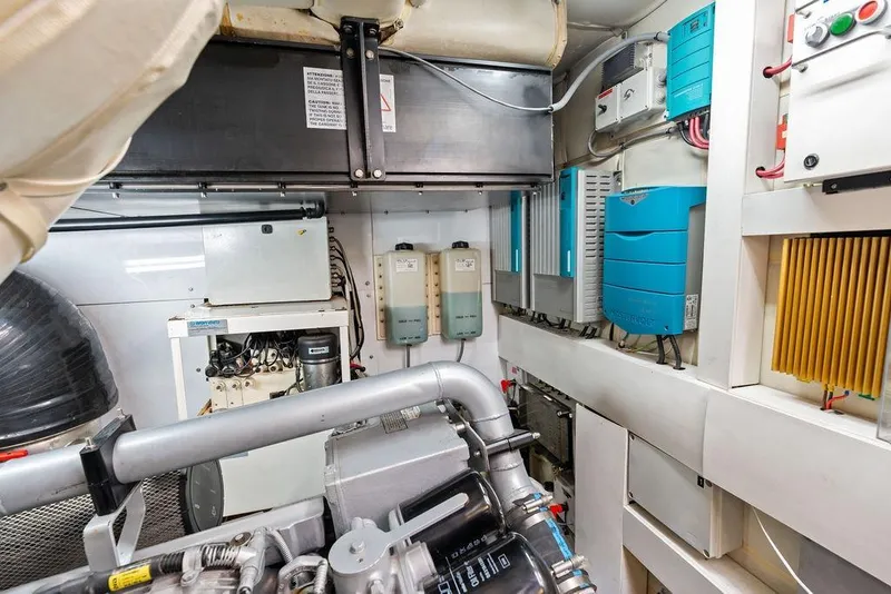 Slide: The Image of Engine room of a 2013 Pershing 64 yacht, showcasing mechanical and electrical systems. - 55