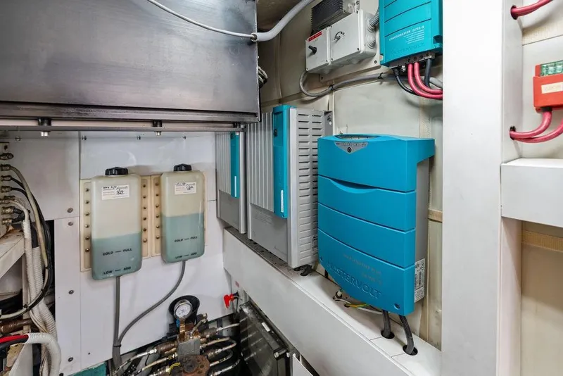 Slide: The Image of Engine room of a 2013 Pershing 64 yacht with electrical equipment and wiring. - 56