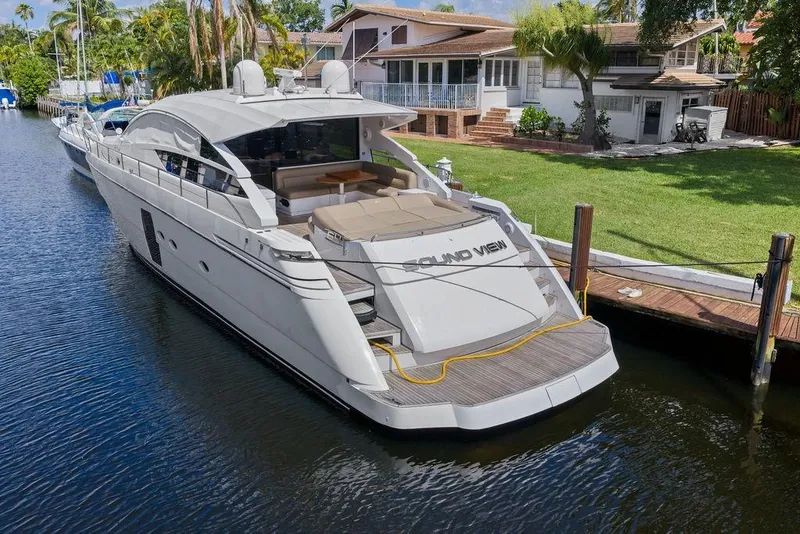 Slide: The Image of Luxury 2013 Pershing 64 yacht docked by waterfront property. - 8