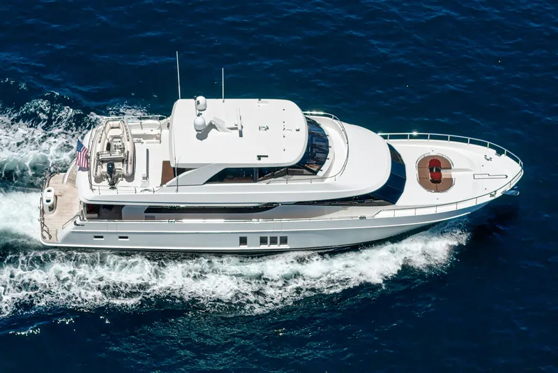 Slide: The Image of Aerial view of a luxury motor yacht cruising through blue water, featuring spacious deck and sleek design. - 10
