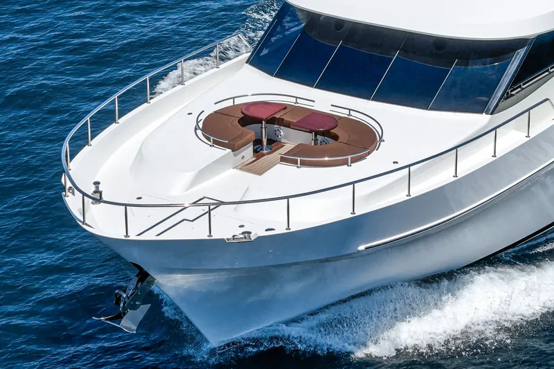 Slide: The Image of The 2015 Ocean Alexander 90 Skylounge Motoryacht cruising on water, featuring a sleek design. - 15