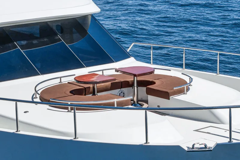 Slide: The Image of An elegant seating area on a yacht's deck overlooking the blue sea. - 16