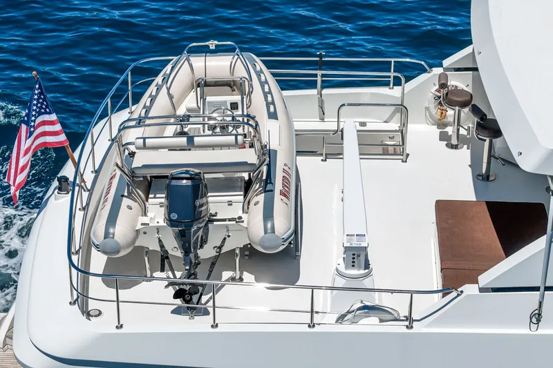 Slide: The Image of A tender is secured on the deck of a motor yacht, surrounded by blue water. - 20