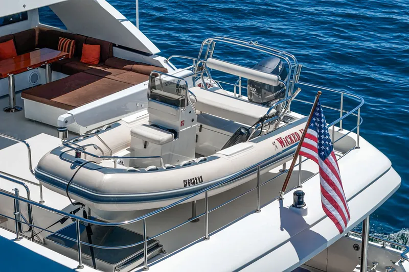 Slide: The Image of A tender is secured on the deck of a luxurious motor yacht, surrounded by blue water. - 21