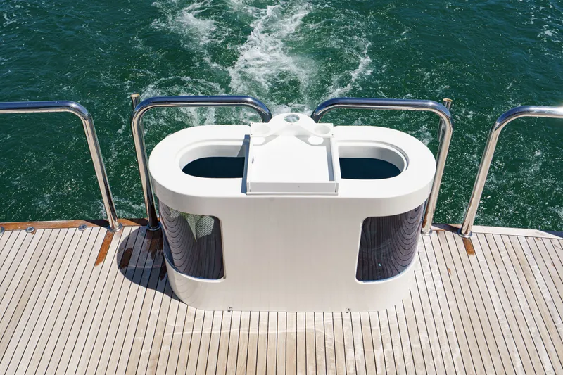 Slide: The Image of The image shows the stern of a yacht with sleek white railings and a modern design. - 23