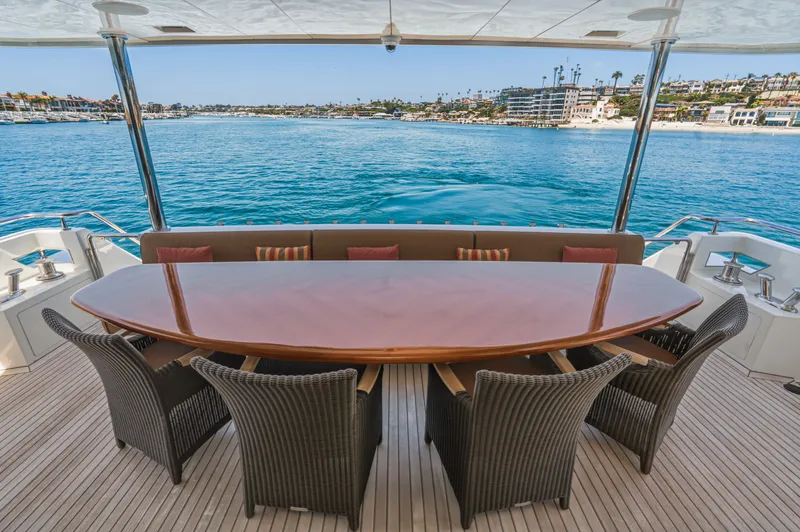 Slide: The Image of An elegant dining table on a yacht overlooking the water and coastline. - 25