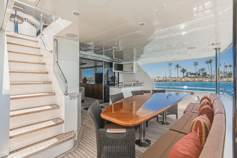 Slide: The Image of The 2015 Ocean Alexander 90 Skylounge Motoryacht features an elegant outdoor dining area overlooking the water. - 27