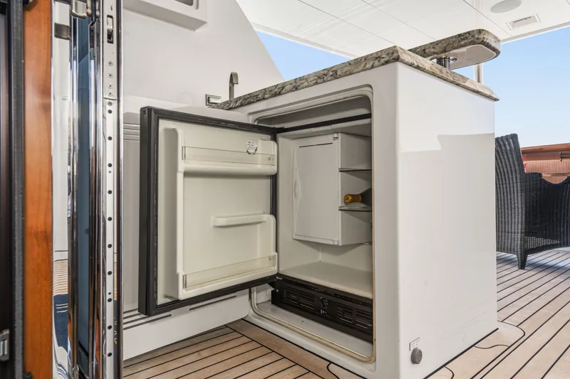 Slide: The Image of Open minibar on a yacht with wooden flooring and rattan furniture. - 29
