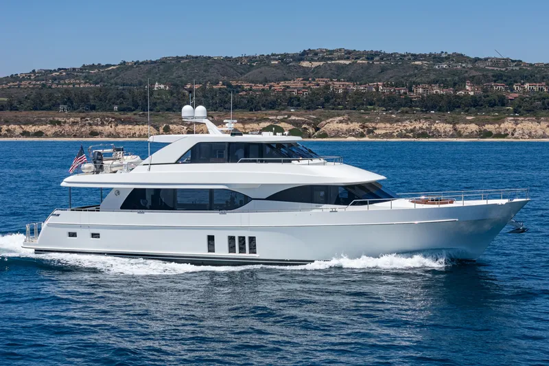 Slide: The Image of 2015 Ocean Alexander 90 Skylounge Motoryacht on the water, with coastal landscape in the background. - 3