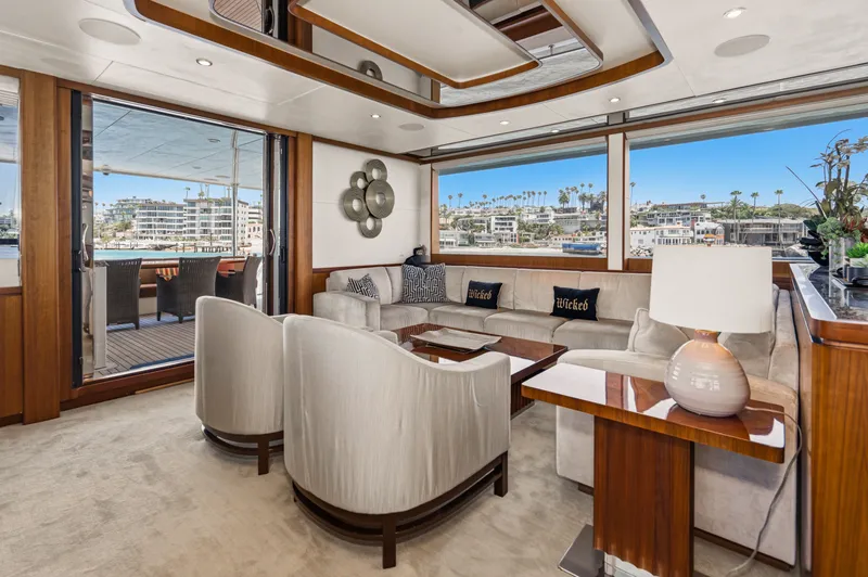 Slide: The Image of Luxurious salon with elegant chairs and a wooden table, surrounded by large windows overlooking the harbor. - 31