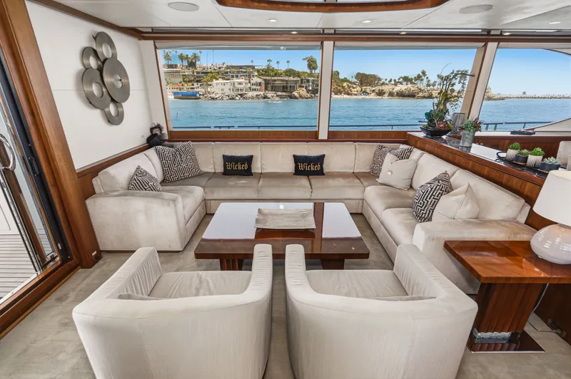 Slide: The Image of Luxurious salon with large windows, comfortable sofas, and a view of the water. - 32