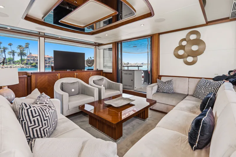 Slide: The Image of Luxurious salon with elegant sofas, wooden table, and large windows overlooking the water. - 34