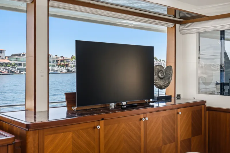 Slide: The Image of A luxurious interior with a large TV and a view of the harbor through a window. - 36