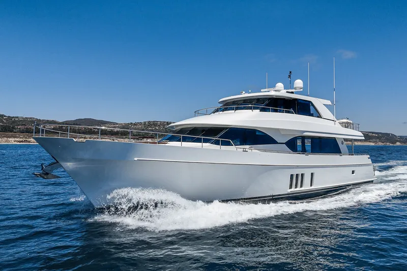 Slide: The Image of A luxurious motor yacht cruising on calm waters under a clear sky. - 4
