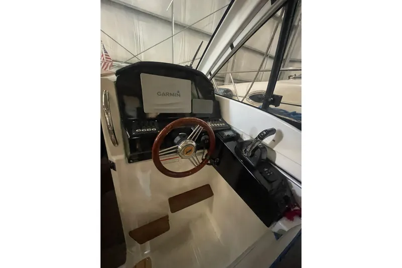 Slide: The Image of 2017 Cutwater C-24 Coupe helm with Garmin navigation and wooden steering wheel. - 10