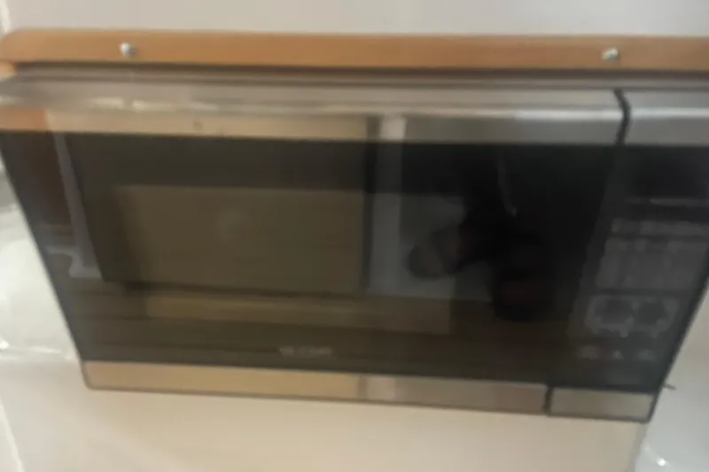 Slide: The Image of Built-in microwave in 2017 Cutwater C-24 Coupe boat interior. - 17