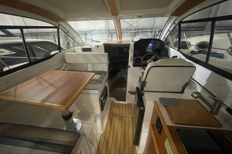 Slide: The Image of 2017 Cutwater C-24 Coupe interior with wood accents and modern helm. - 7