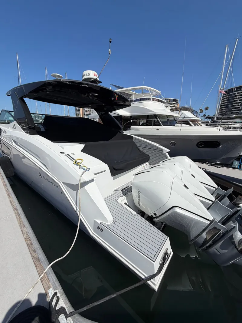 Slide: The Image of A luxurious white yacht with two outboard engines docked at a sunny marina. - 1