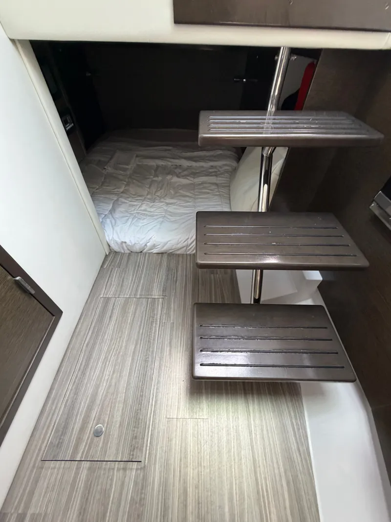 Slide: The Image of Interior of the Cruisers Yachts 38 GLS with wooden steps and a sleeping area. - 8