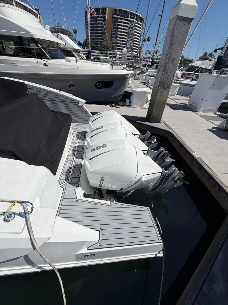 Slide: The Image of The image shows a 2021 Cruisers Yachts 38 GLS boat with three outboard engines at the dock. - 5