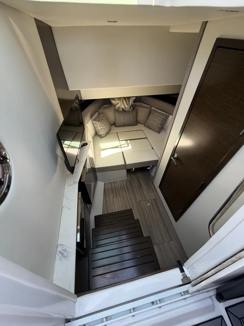 Slide: The Image of The cabin of the 2021 Cruisers Yachts 38 GLS features a cozy seating area with a TV. - 11