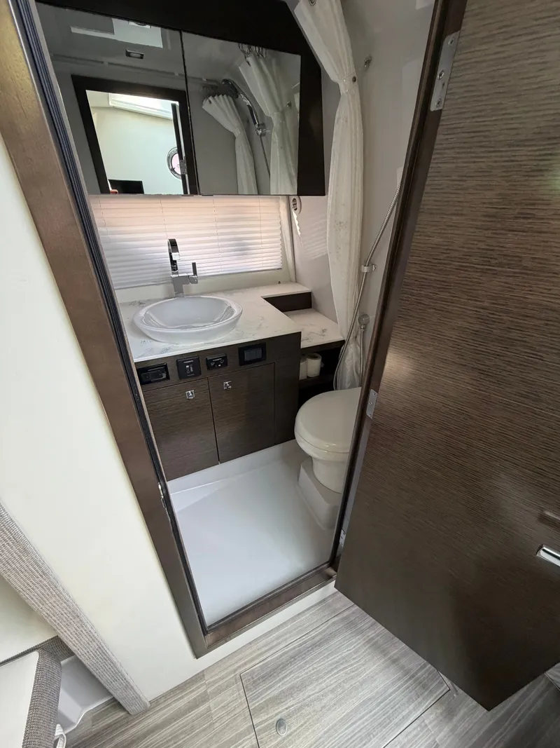 Slide: The Image of The image shows a modern yacht bathroom with a sink, toilet, and mirror. - 9