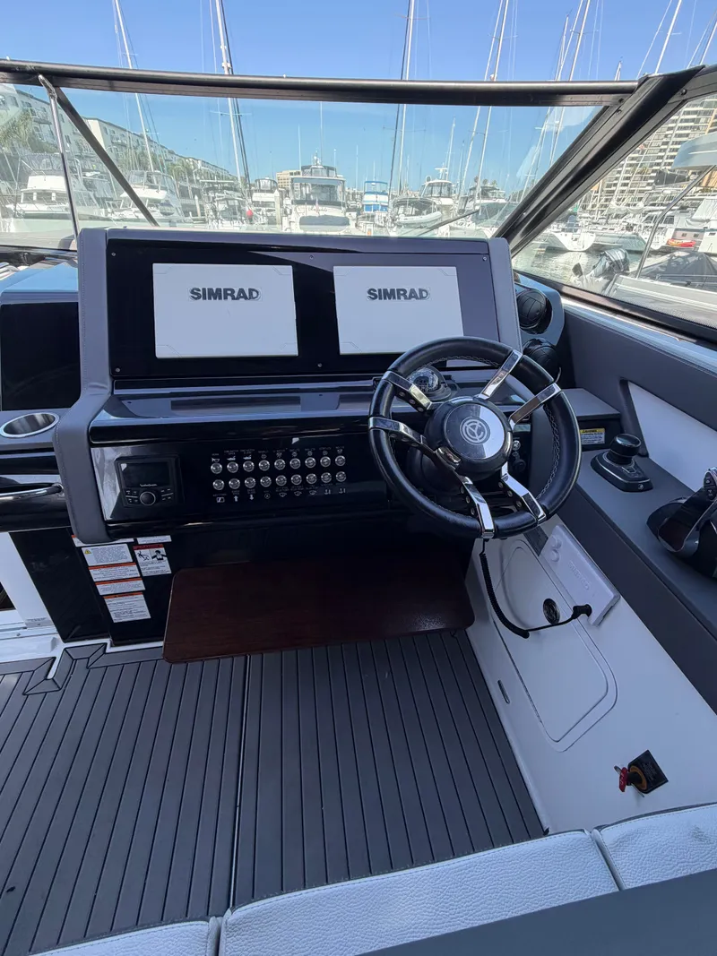 Slide: The Image of The image shows the helm of a 2021 Cruisers Yachts 38 GLS with two Simrad screens. - 6