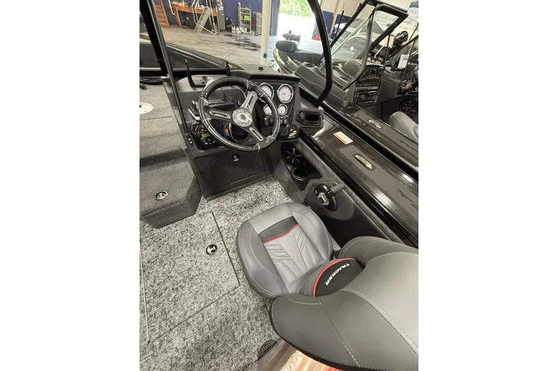 Slide: The Image of Interior of 2026 Tracker Targa V-19 WT boat, featuring steering wheel and seating. - 15