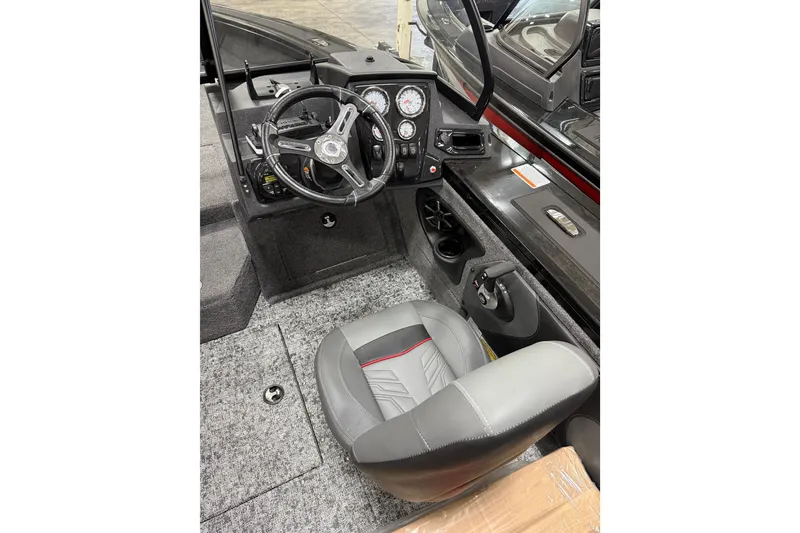Slide: The Image of Interior of 2026 Tracker Targa V-19 WT boat with steering wheel and dashboard controls. - 17