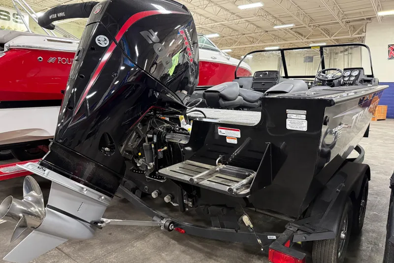 Slide: The Image of 2026 Tracker Targa V-19 WT boat with powerful outboard motor in showroom. - 19