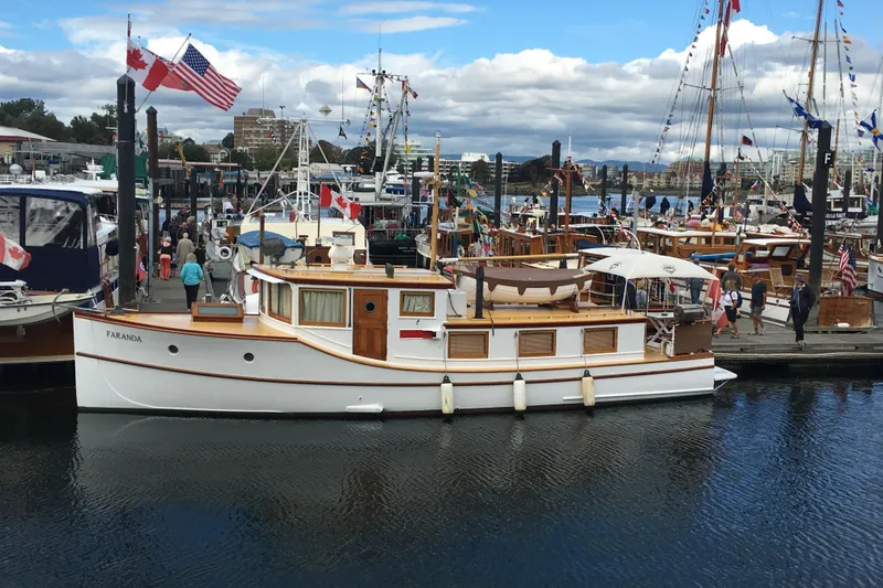 The Image of 1942 Grenfell 42 Custom boat docked at marina, adorned with flags, surrounded by people. - 0