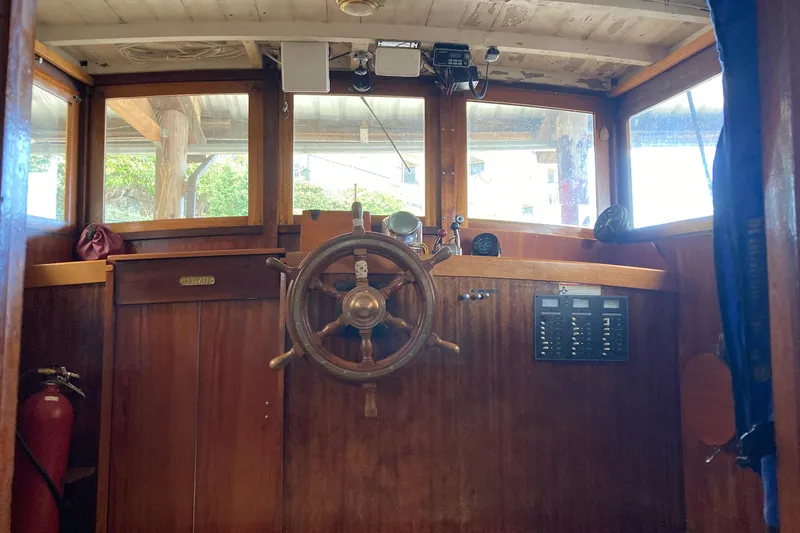 Slide: The Image of Interior of a 1942 Grenfell 42 Custom boat with wooden steering wheel and control panel. - 3