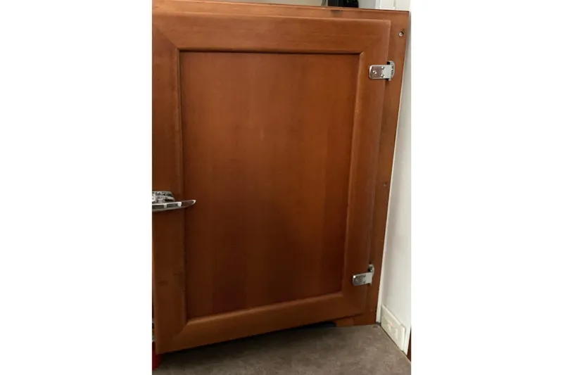 Slide: The Image of Wooden cabinet door with metal hinges, part of a 1942 Grenfell 42 Custom model. - 9