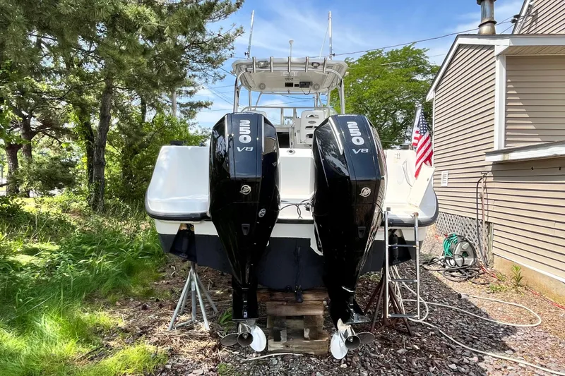 Slide: The Image of 2006 Boston Whaler 285 Conquest with dual Mercury 250 V8 engines, parked outdoors. - 11
