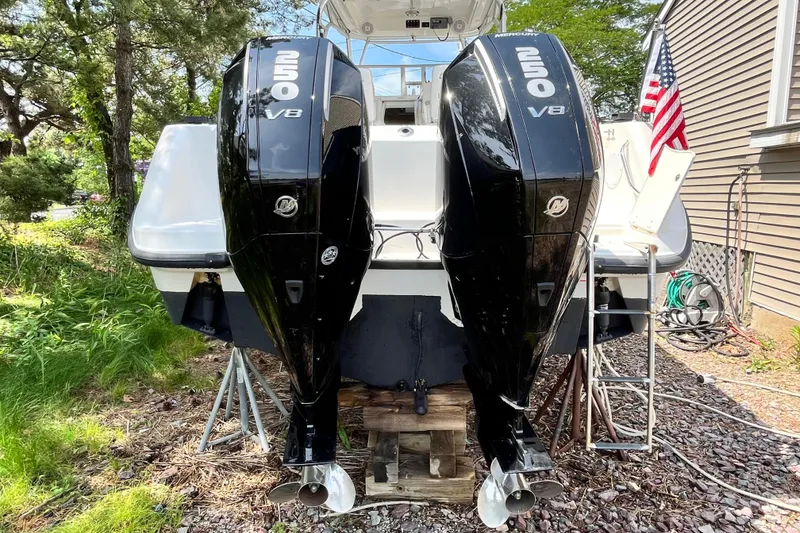 Slide: The Image of 2006 Boston Whaler 285 Conquest with twin Mercury 250 V8 engines, parked outdoors. - 12
