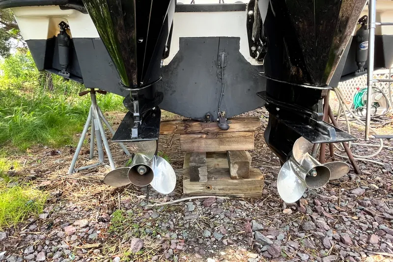 Slide: The Image of Boston Whaler 285 Conquest 2006 boat propellers on dry land, supported by wooden blocks. - 13
