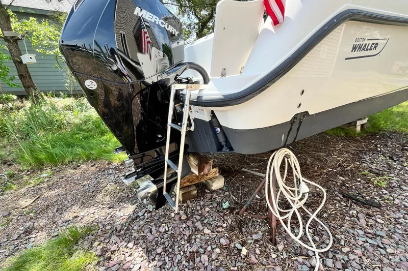 Slide: The Image of 2006 Boston Whaler 285 Conquest boat with Mercury engine on dry land. - 14