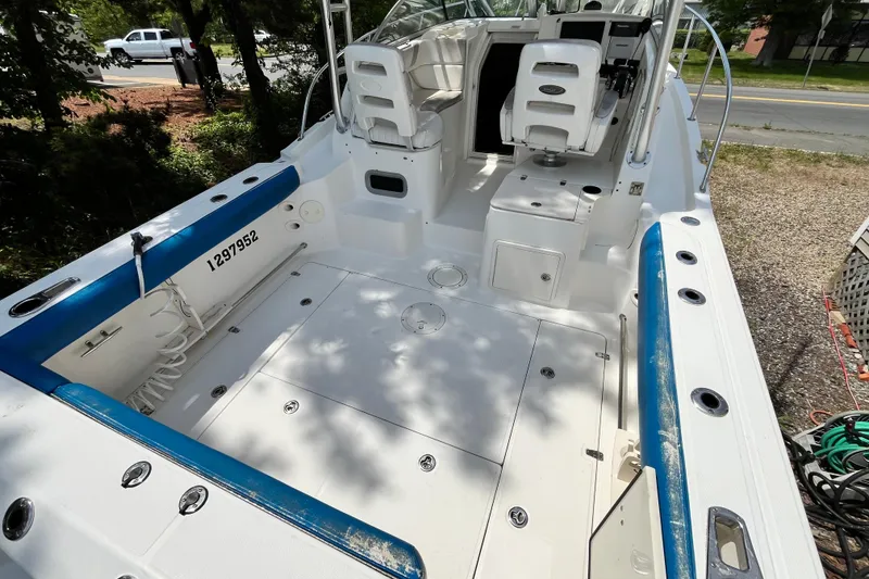 Slide: The Image of 2006 Boston Whaler 285 Conquest boat interior with seating and storage compartments. - 16
